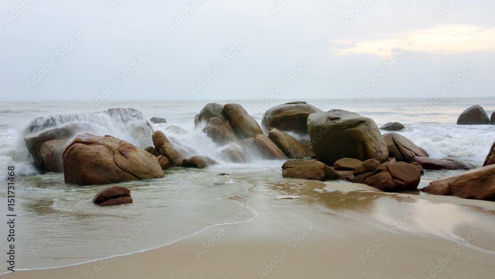 The waves hit the rocky coast in the morning
