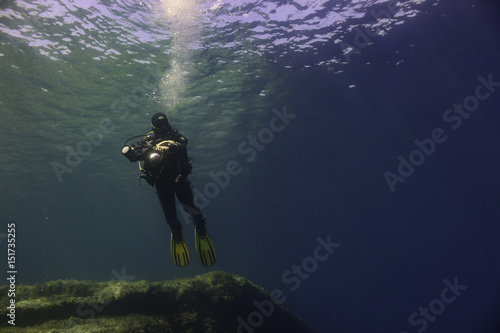 Underwater Photographer Hovering Over a Reef