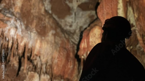 Man with headlamp inside cave