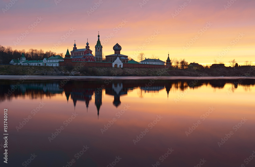 Saint Nicholas Monastery for Men in Staraya Ladoga, view from a bank of Volkhov river at sunset.