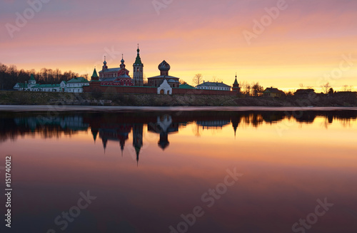 Saint Nicholas Monastery for Men in Staraya Ladoga, view from a bank of Volkhov river at sunset.