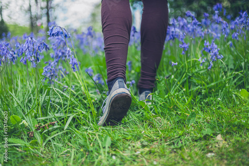 Feet of woman walking in meadow