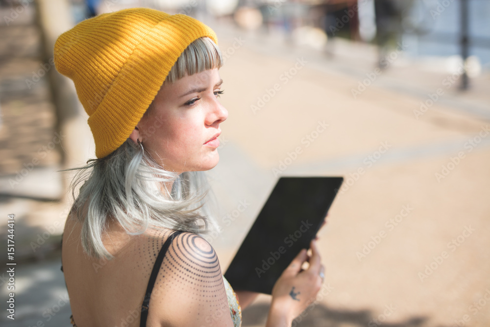 Young lady using her tablet outdoors