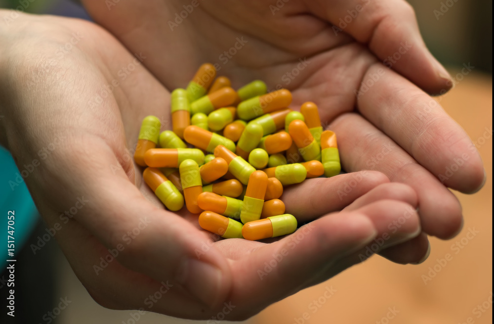 Woman's hands holding a lot of pills. Woman's hands holding a lot of pills.