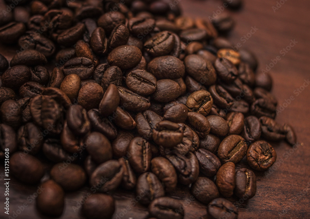 Fototapeta premium Black coffee beans on a brown tree