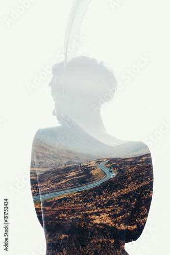 Woman with feather as a silhouette in double exposure