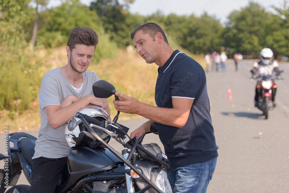 motorbike teacher showing student how to pass