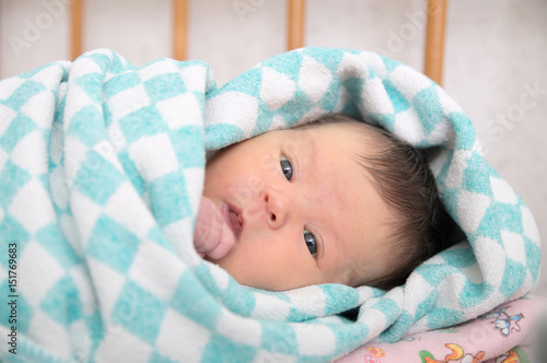 Newborn jaundice, baby portrait in blanket