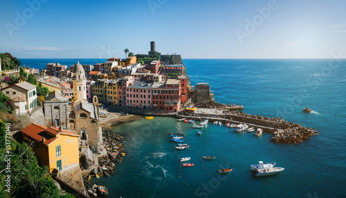 Panoramic overview of Vernazza village with colorful houses on bright summer sunny day, Cinque Terre National Park, La Spezia region, Liguria. Picturesque scene travel postcard.