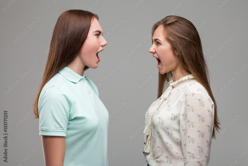 Girls screams at each other, studio photo shoot Girls screams at each other, studio photo shoot
