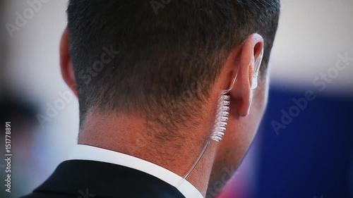 Detail with a bodyguard wearing in ear headset