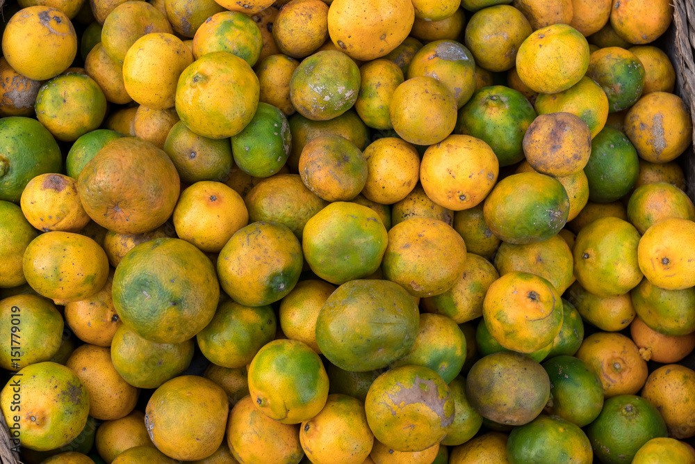 Fresh mandarin oranges on an organic food market of tropical Bali island, Indonesia. Mandarin background.