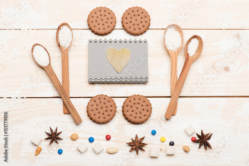 Wooden spoons and cookies vintage composition on light background