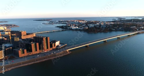 Lapinlahti bridge, Cinema 4k aerial pan view of cars on lapinlahden silta, on a sunny spring evening, in Ruoholahti, Helsinki, Finland photo