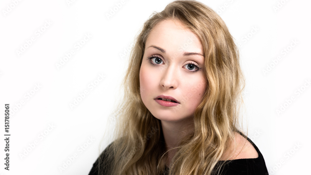 Headshot of a young woman with long blonde hair isolated against a white background. Headshot of a young woman with long blonde hair isolated against a white background.
