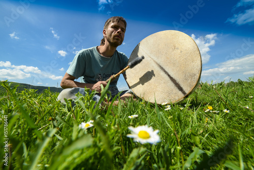 Man with a tambourine on the grass, Ukraine, May 2017, Ivano-Frankivsk region photo