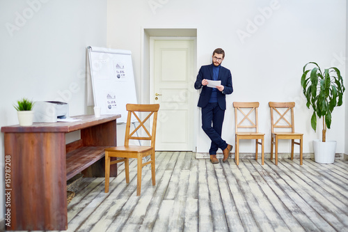 Serious manager or employee preparing report of his work © pressmaster