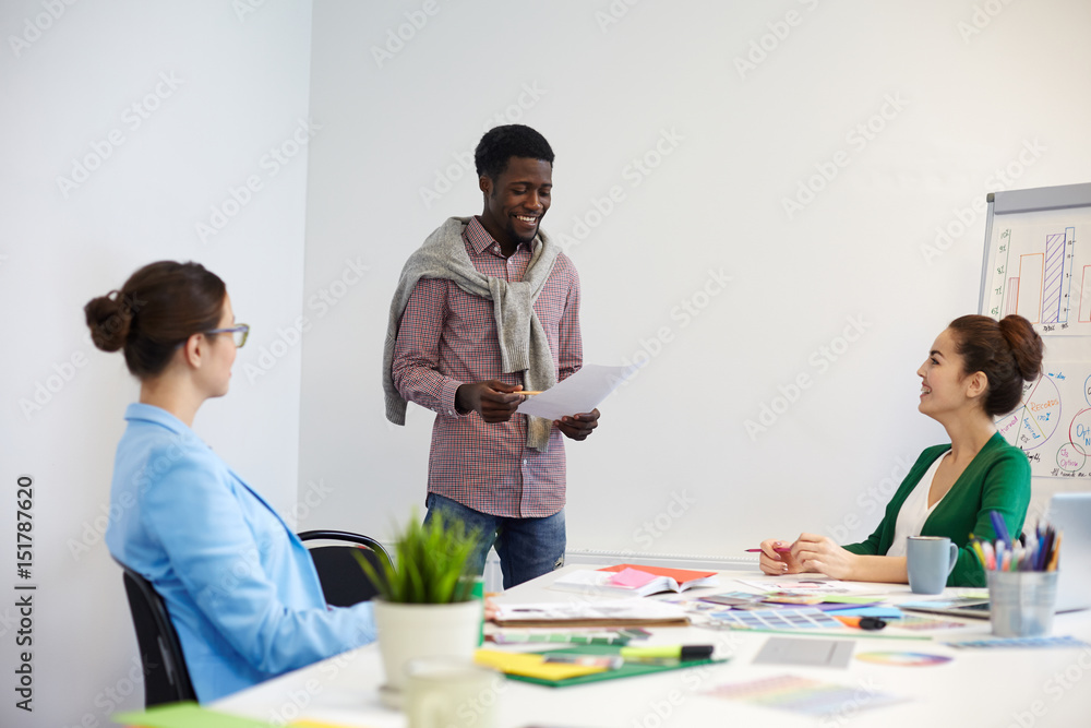 Young employees brainstorming and consulting about specific moments of their report Young employees brainstorming and consulting about specific moments of their report