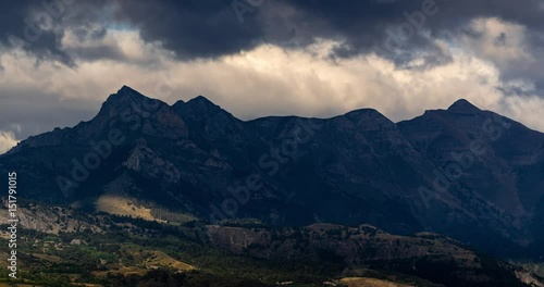 Passing clouds on the mountain peaks of Aiguille, Arche and Piolit in the Ecrins National Park (time lapse). Hautes-Alpes, Southern French Alps, France  photo