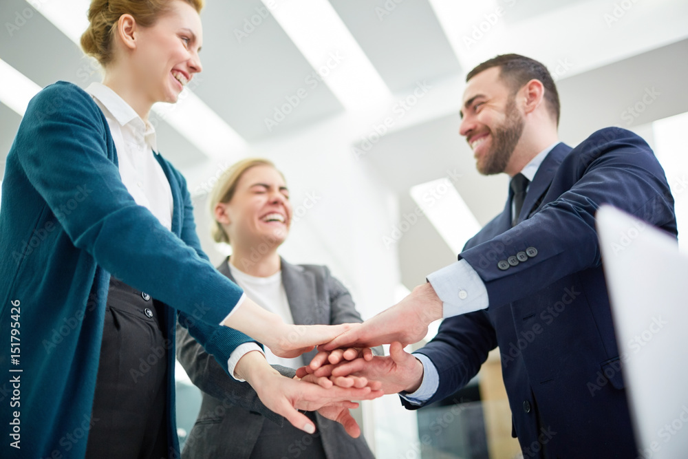 Successful business team keeping their palms on top of each other