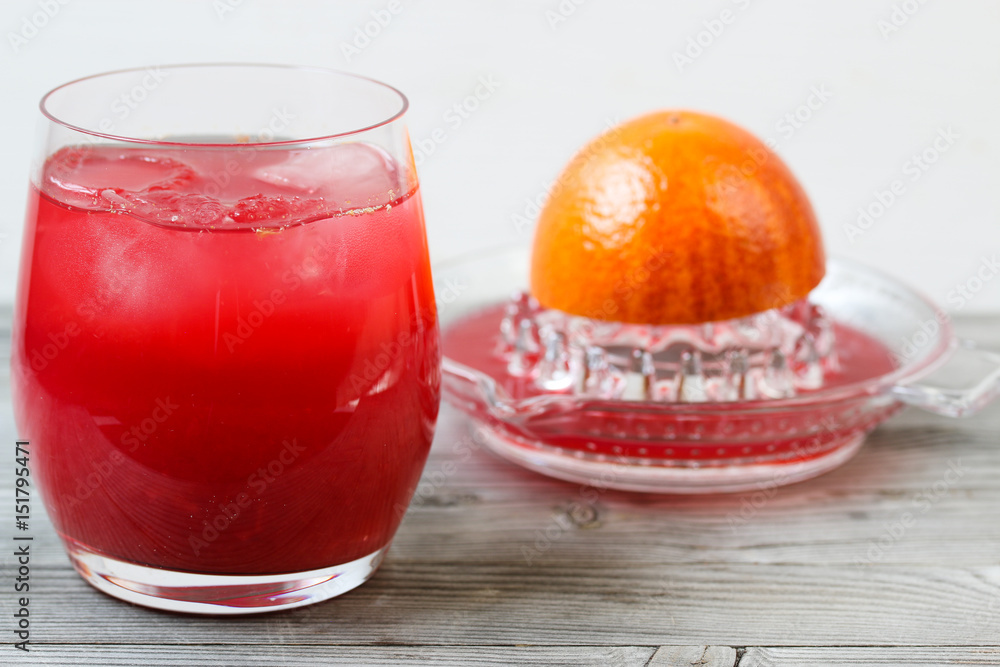 Red orange juice. Grey wooden background. Top view. Red orange juice. Grey wooden background. Top view.