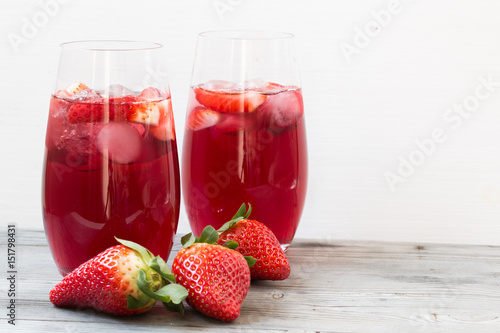 Strawberry drink. Grey white wooden background. Close up photo.