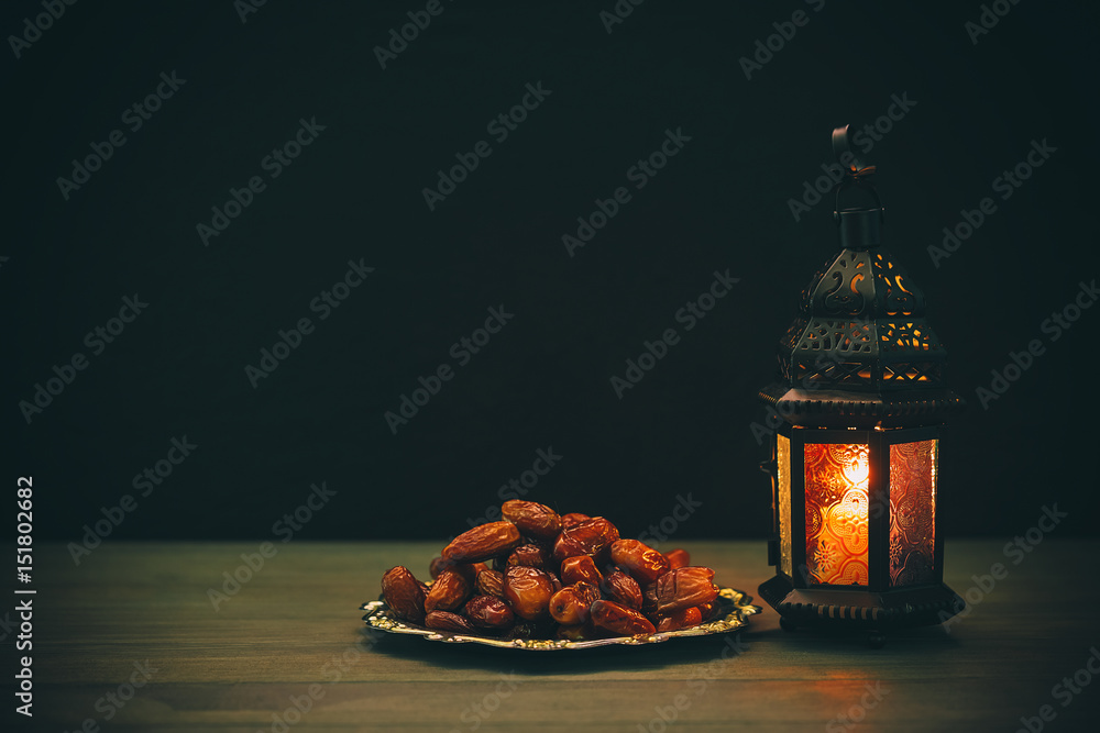 Fototapeta premium The Muslim feast of the holy month of Ramadan Kareem. Beautiful background with a shining lantern Fanus. Free space for your text.