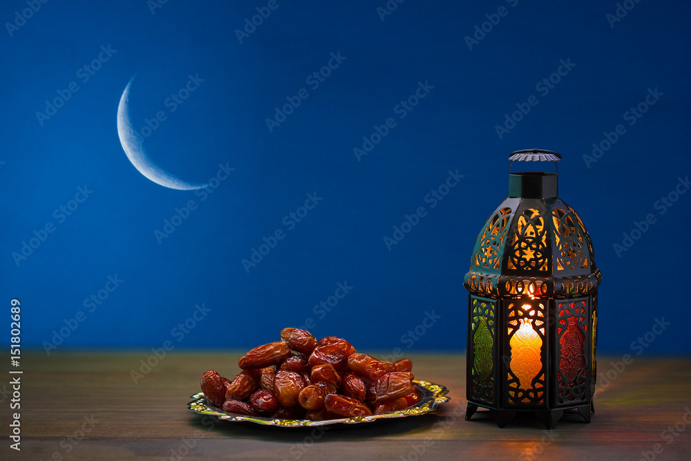 Fototapeta premium The Muslim feast of the holy month of Ramadan Kareem. Beautiful background with a shining lantern Fanus. Free space for your text.