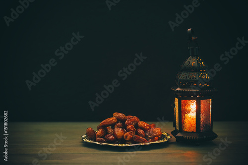 The Muslim feast of the holy month of Ramadan Kareem. Beautiful background with a shining lantern Fanus. Free space for your text.