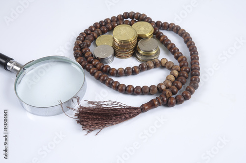 Rosary and coins on white background. Islamic business concept.