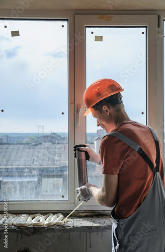 Worker is using a polyurethane foam. photo