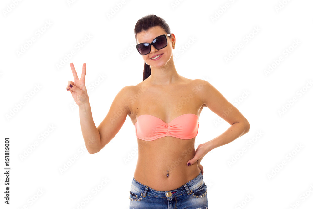 Woman in swimming suit, shorts and sunglasses Woman in swimming suit, shorts and sunglasses