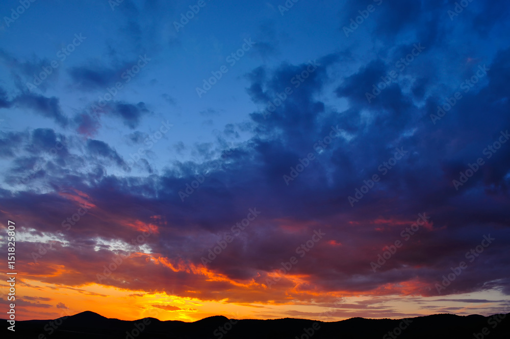 Sunset with clouds, in orange and purple shades Sunset with clouds, in orange and purple shades