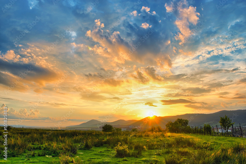 Rural sunset with colorful clouds.