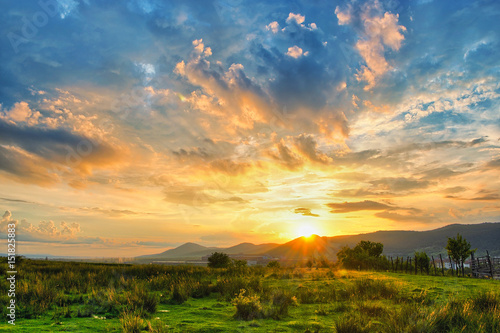 Rural sunset with colorful clouds.