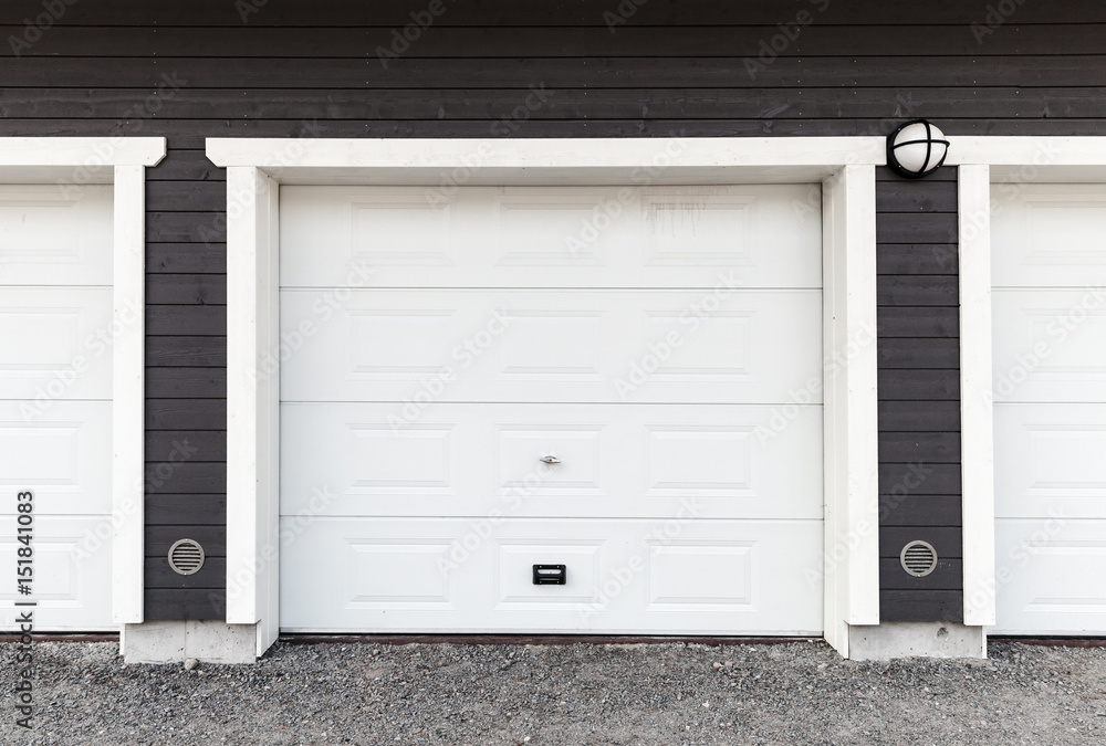 White garage wall with white closed gates White garage wall with white closed gates