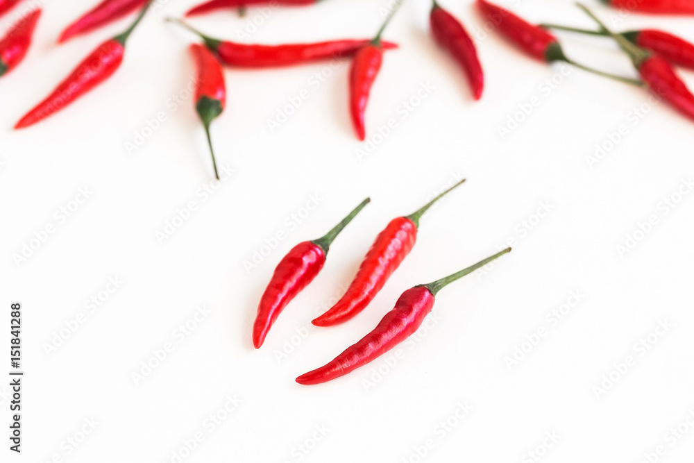 red hot chili peppers, popular spices concept - closeup on few clean and fresh pods of red chili peppers on white background, green tails, collage of freely lying peppers, selective focus red hot chili peppers, popular spices concept - closeup on few clean and fresh pods of red chili peppers on white background, green tails, collage of freely lying peppers, selective focus
