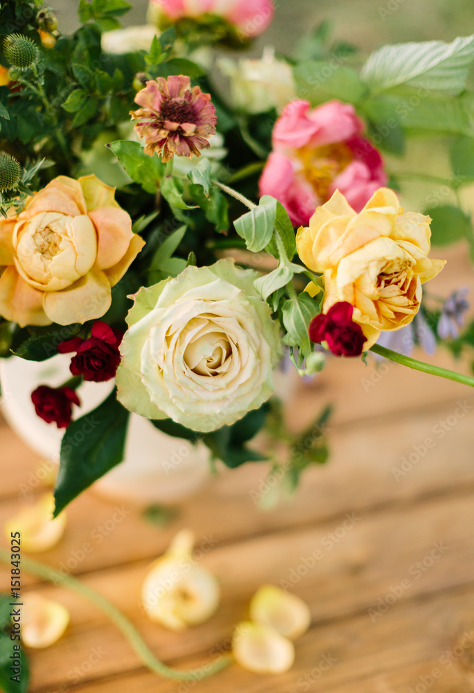 Fototapeta premium bouquet, holiday flower, gift and floral arrangement concept - top view of a delightful summer fresh white and yellow roses and pink peonies, decoration of festive bouquet on wooden table background