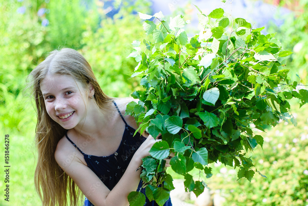 Beautiful little girl with a bouquet of green leaves Beautiful little girl with a bouquet of green leaves