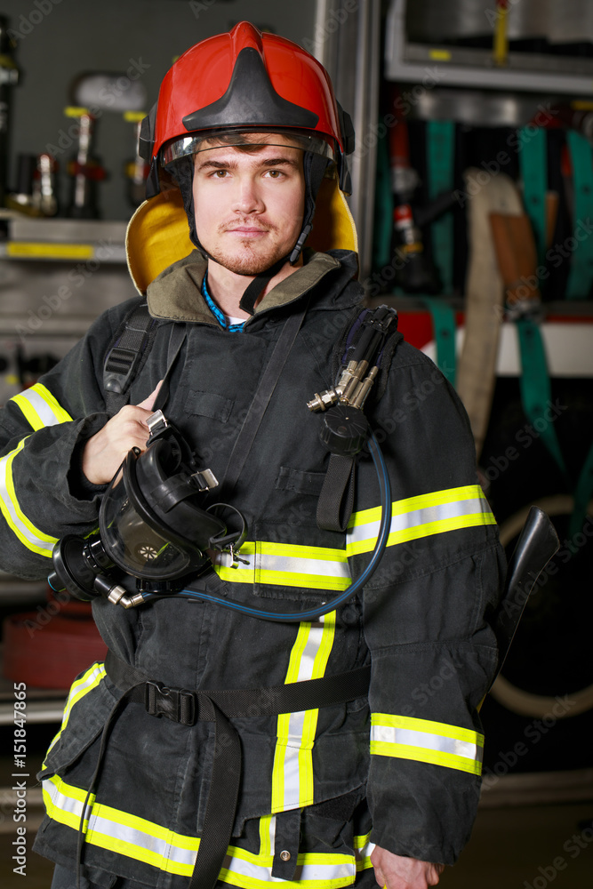 Portrait of a young fireman on the background of a fire truck Portrait of a young fireman on the background of a fire truck