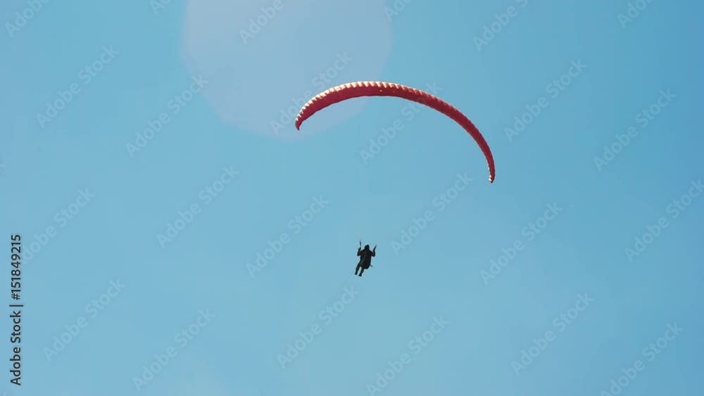 The paraglider in the sky, flies in the air streams. An extreme hobby for wealthy men. Modern equipment The paraglider in the sky, flies in the air streams. An extreme hobby for wealthy men. Modern equipment