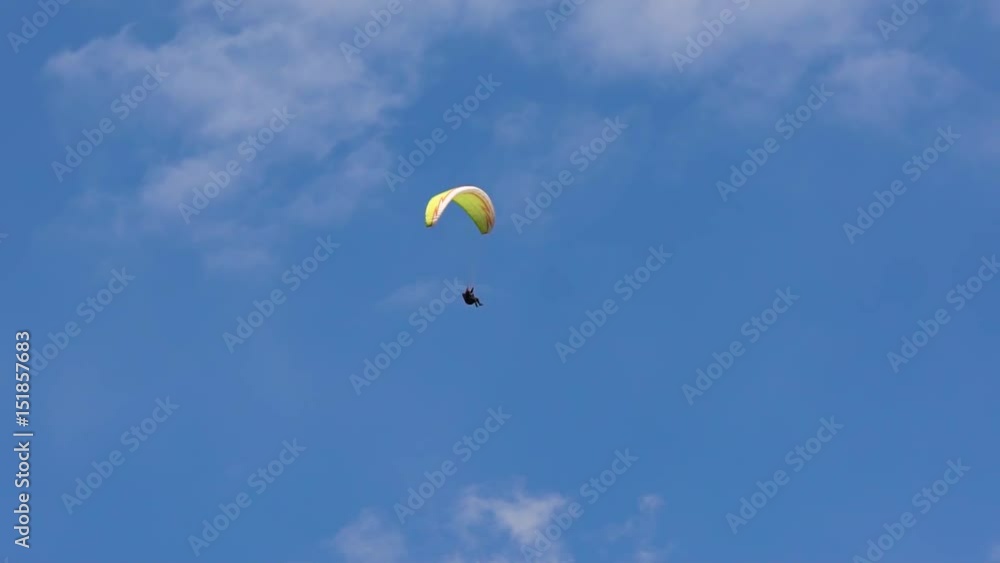 The paraglider in the sky, flies in the air streams. Freedom, when you fly like a bird, at a tremendous height. Extreme sports. The paraglider in the sky, flies in the air streams. Freedom, when you fly like a bird, at a tremendous height. Extreme sports.