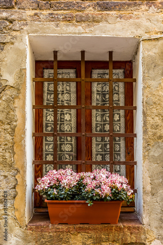 Adorned windoes in the medieval streets of San Gimignano in Tuscany  - 2 photo