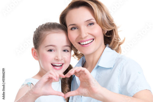 mother and young daughter with heart shape sign