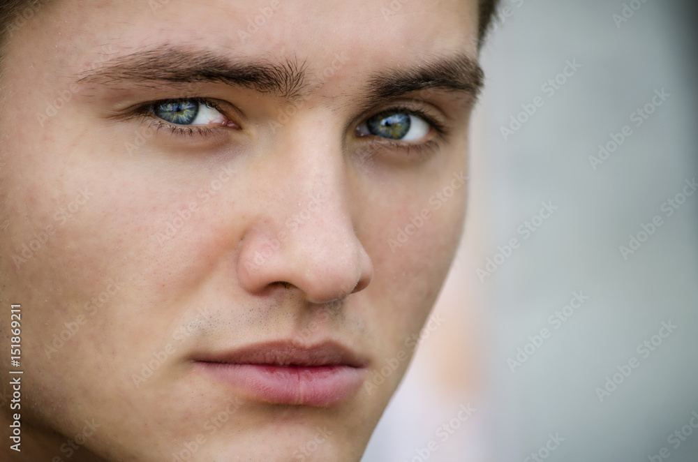 Obraz premium Handsome blond young man outdoors, looking away to a side