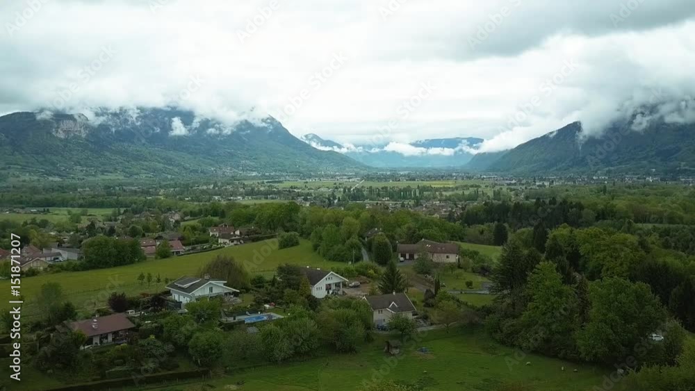 Aerial View of Green Fields, Small Village and Amazing Mountains Aerial View of Green Fields, Small Village and Amazing Mountains