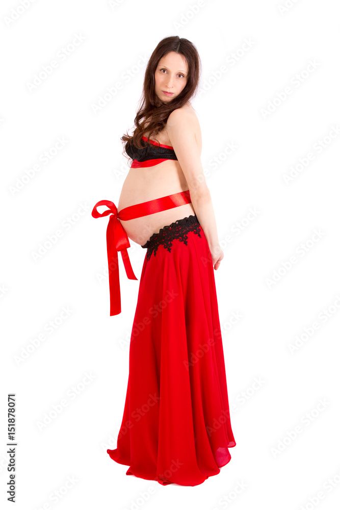 A pretty young pregnant girl posing on white background
