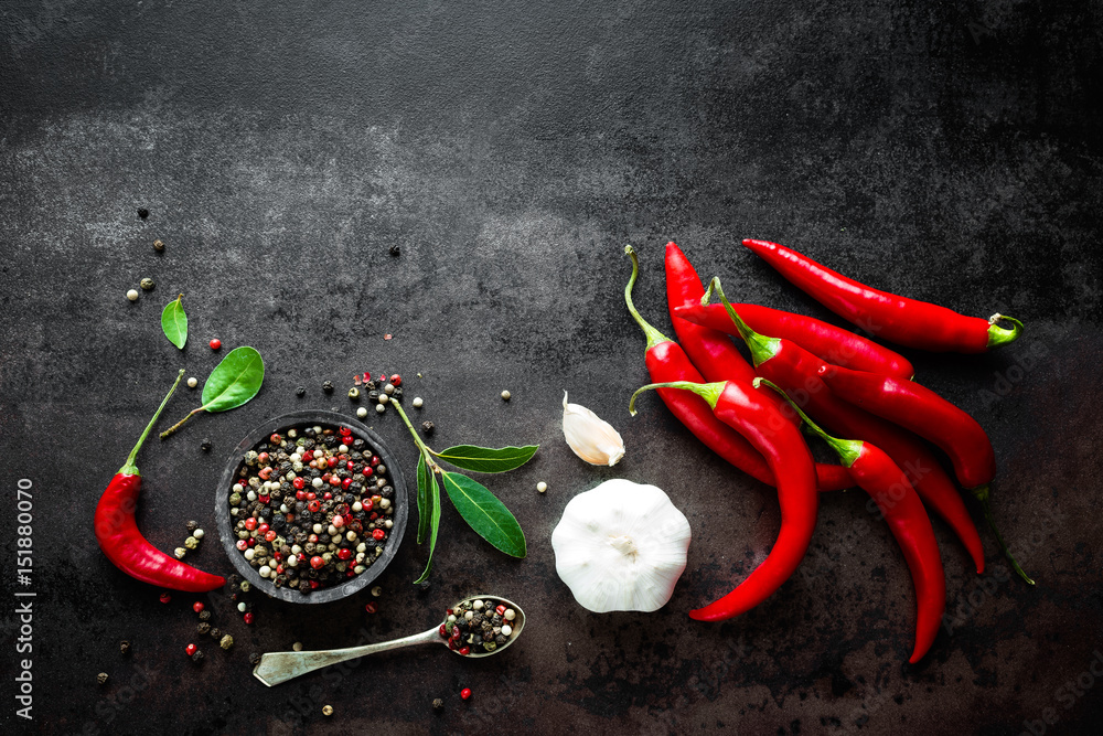 Red hot chili pepeprs and peppercorns on black metal background, top view - obrazy, fototapety, plakaty 