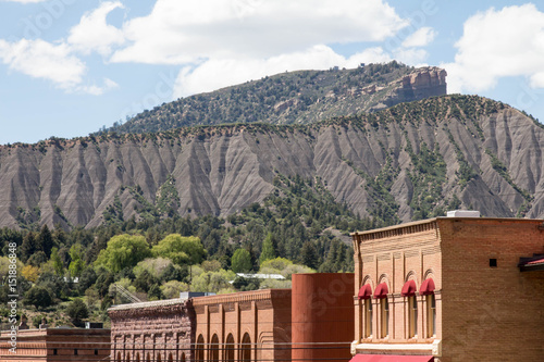 Brick buildings in downtown Durango, Colorado with Hogsback mountain and Perin's peak