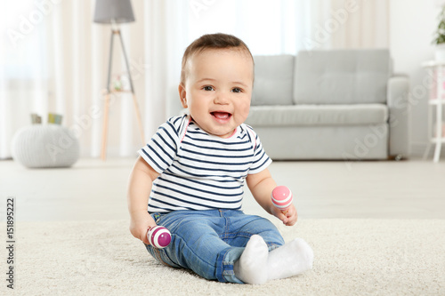 Cute little baby with rattl...